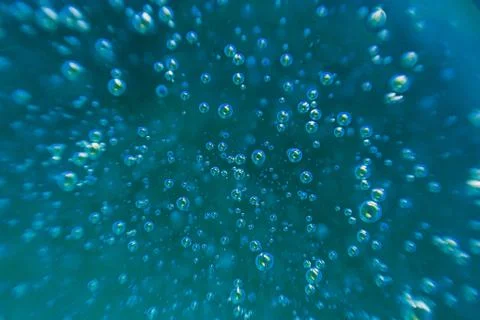 Blue background, texture with bubbles in some liquid. Stock Photos