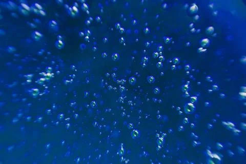 Blue background, texture with bubbles in some liquid. Stock Photos