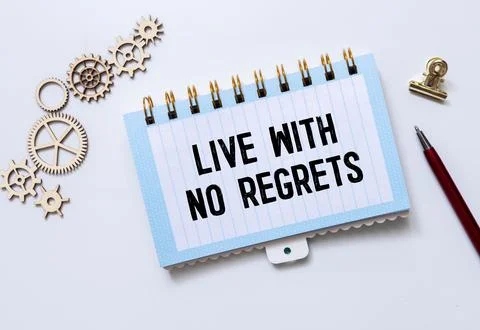 On blue background, torn paper with text written NO REGRET Stock Photos