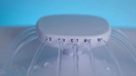 On a blue background is a white plastic drinking fountain for animals. Water Stock Footage 212434751