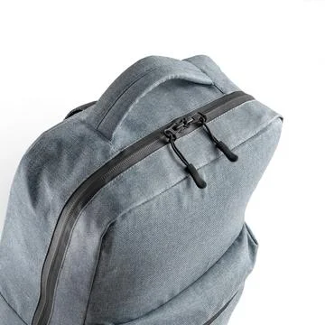 Blue backpack with a large zippered compartment and top carrying handle. Stock Photos