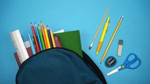 Blue backpack overflowing with various school supplies Stock Photos