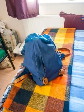 Blue backpack rucksack on bed close up student Stock Photos