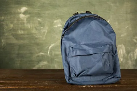 Blue backpack wooden table Stock Photos