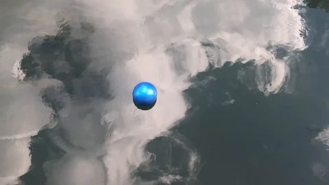 Blue ball floating on river. Clouds reflected on the water. Stock Footage 126282671