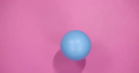 Blue Ball on Pink Background Stock Footage 212647954