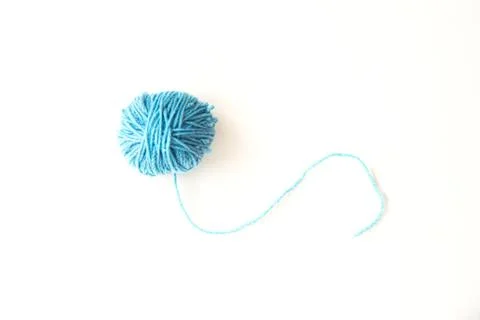 Blue ball of woolen thread on a light background Stock Photos