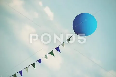 Blue balloon floating in the blue sky Stock Photos