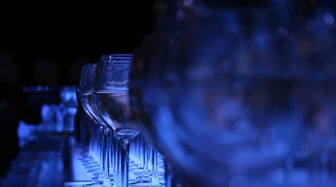 Blue bar glasses bartender pours Stock Footage 4570324