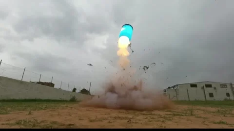 Blue barrel bomb explosion in slow motion showing fireball, shockwave Stock Footage 327909156