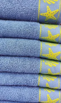 Blue bath towels folded and stacked Stock Photos