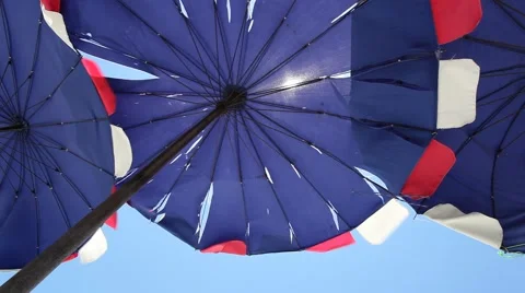 Blue beach umbrella on the wind and sky as background Stock Footage 48421476