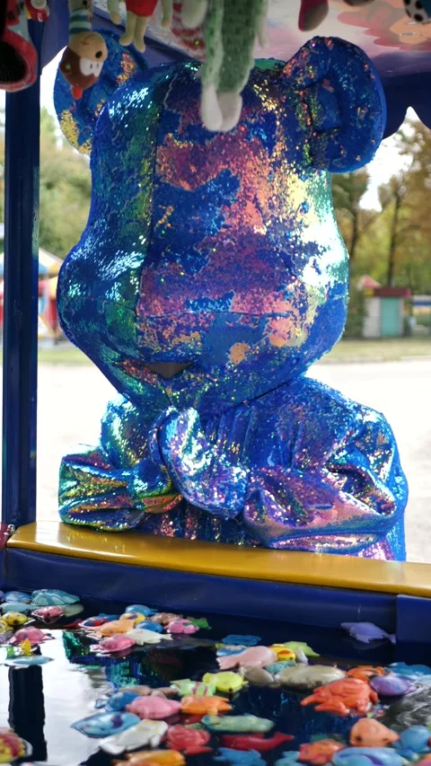 Blue bear mascot playing with plastic toy fish fishing. Magnetic fishing toys Stock Footage 289387180