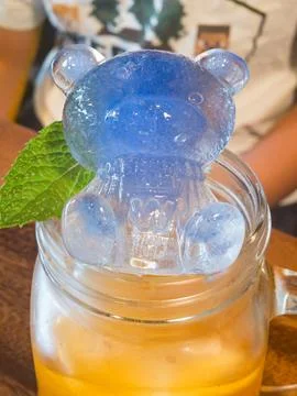 Blue bear shaped ice cube in mason jar drink with mint Stock Photos