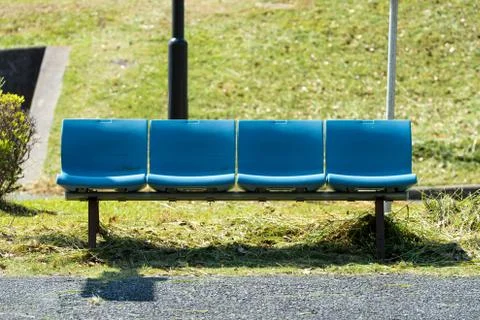 Blue bench at the bus stop.  Stock Photos