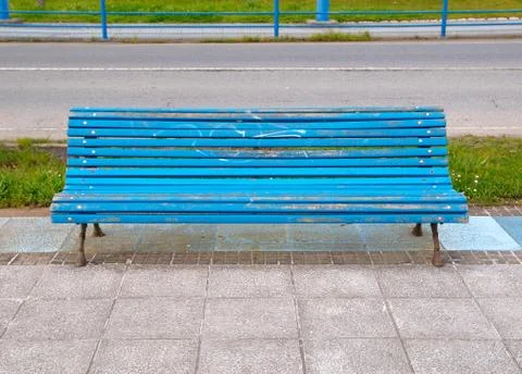 Blue bench in horizontal composition Stock Photos