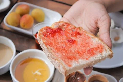 Blue berry jam on bread on table, Stock Photos