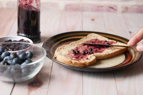Blue berry jam on bread on table, 스톡 사진