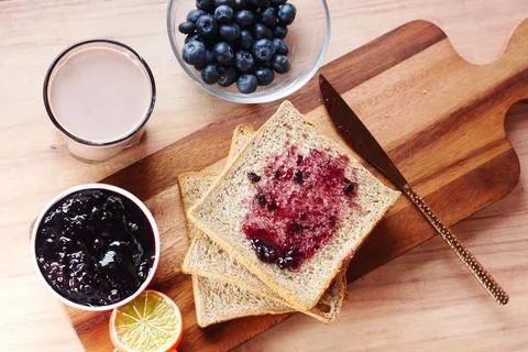 Blue berry jam on bread on table, Stock Photos