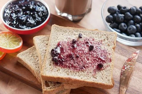 Blue berry jam on bread on table, Stock Photos