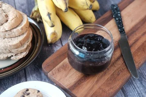 Blue berry jam in container on table Stock Photos