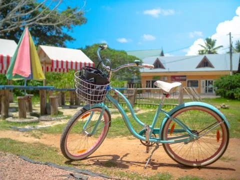 Blue bicycle with a basket in a picnic area in the Seychelles Stock Photos