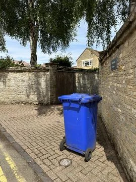 Blue bin in front of the house Stock Photos
