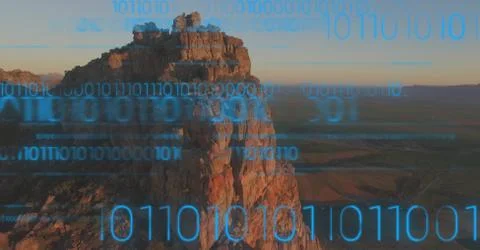 Blue binary code against cliff Foto stock