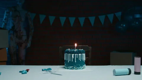 Blue birthday cake on the table with one candle Video stock 256734756
