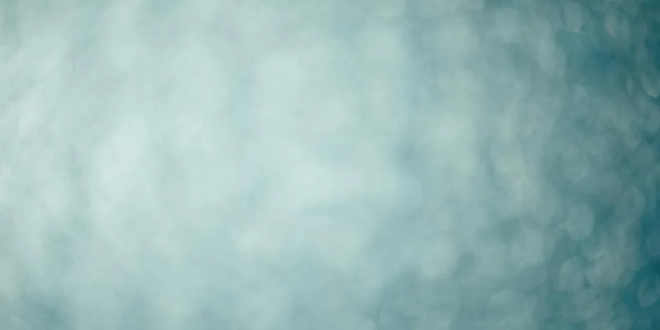Blue blurred abstract background. Defocus light glitter. Stock Photos