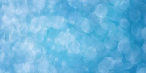Blue blurred abstract background. Defocus light glitter. Stock Photos