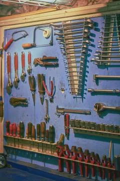 Blue board in ship's engine workshop with plent different types of tools: wre Stock Photos