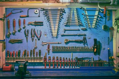 Blue board in ship's engine workshop with plent different types of tools: wre Stock Photos