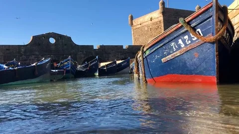 A blue boat floating on the shore Stock-Footage 84305199