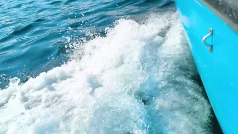 Blue  boat wake splashing through deep blue sea Stock Footage 340533287