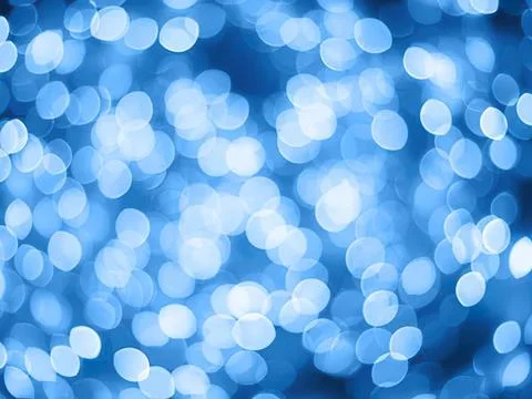 Blue bokeh lights background with soft glowing circles Stock Photos