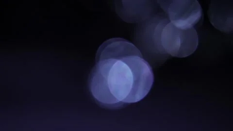 Blue bokeh moving in a bunch on a black background 库存影片 318844249