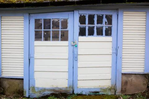 Blue bordered old garage doors Stock Photos