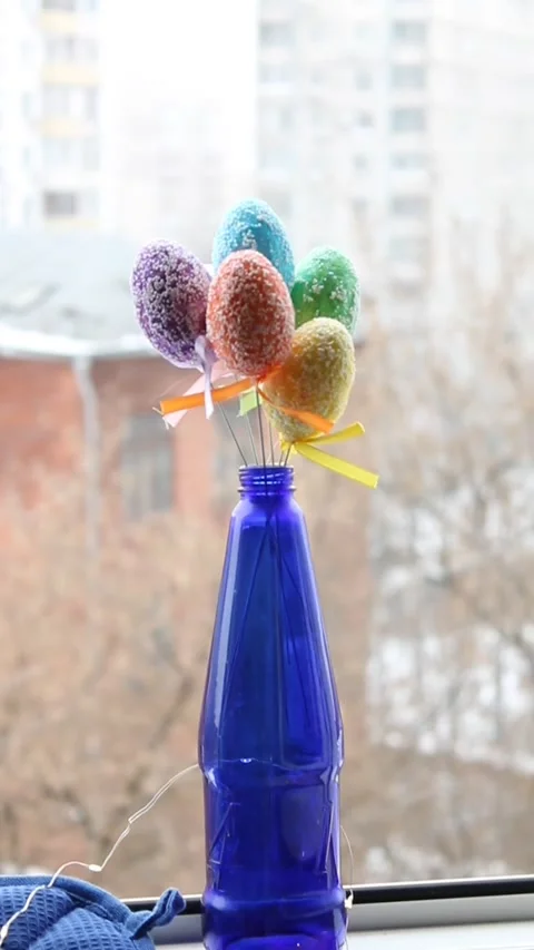 Blue bottle home decor with snowing backspace easter egg Stock Footage 170077341