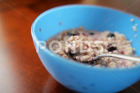 Blue Bowl of Oats and Berries Stock Photos