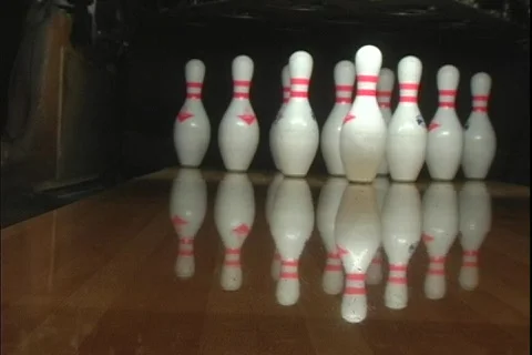 A blue bowling ball rolls down the lane knocking over nine pins. Stock Footage 340649