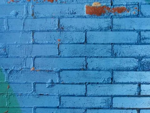 Blue brick wall texture background detail broken and worn on the outside Stock Photos