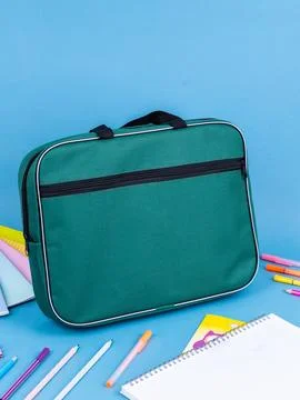 Blue  briefcase folder for documents and school items on a bright blue table  Stock Photos