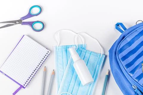 Blue briefcase, school items and personal protective equipment during quara.. Stock Photos