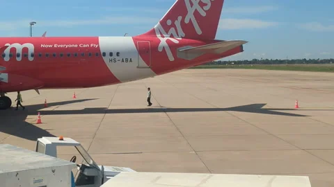 Blue brown red white ground crew below air asia plane Stock Footage 224804331