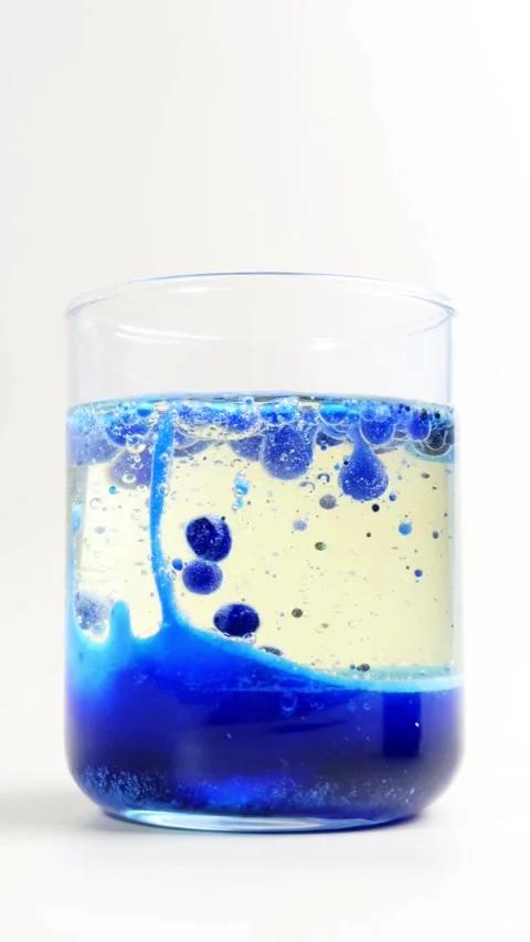 Blue bubbles move through oil in a clear glass Stock-Footage 331774698