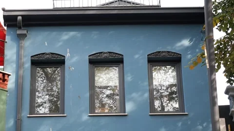 Blue building wall with three windows reflecting trees and sky in dynamic n.. Stock Footage 332264190
