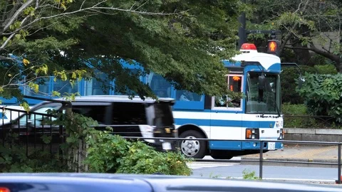 A blue bus making its way on the road in Tokyo Japan Stock Footage 121371796