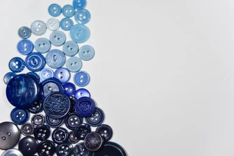 Blue buttons of different shape and size on the white background. Selective f Stock Photos