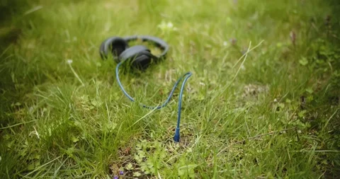 A blue cabel and jack plug of headphones connected to Earth Stock Footage 131176111